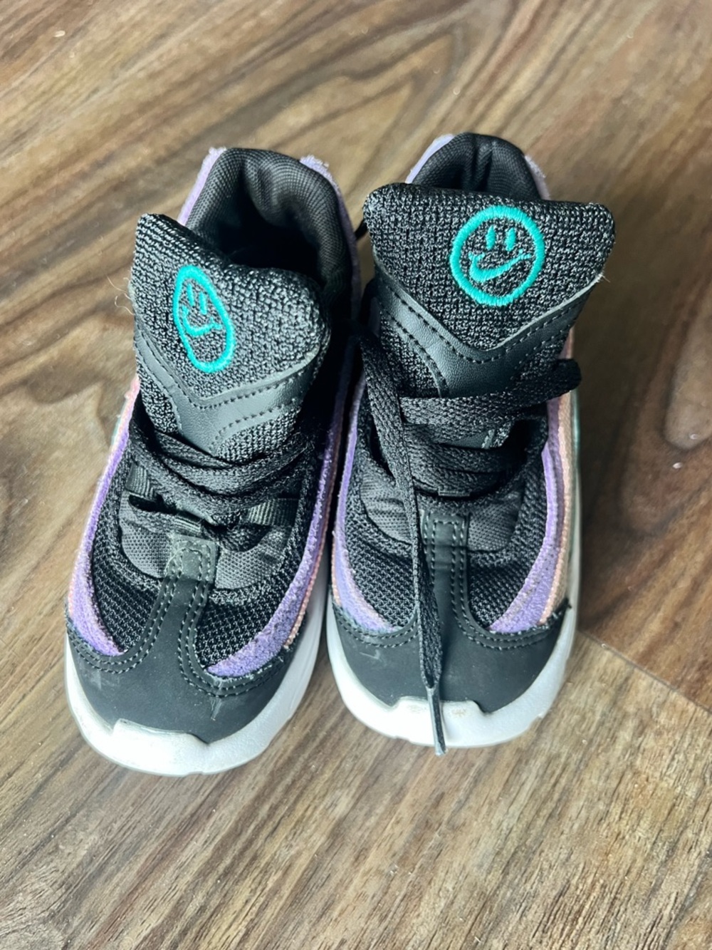 Nike Kids Black Sneakers with Purple Trim and Teal Logo